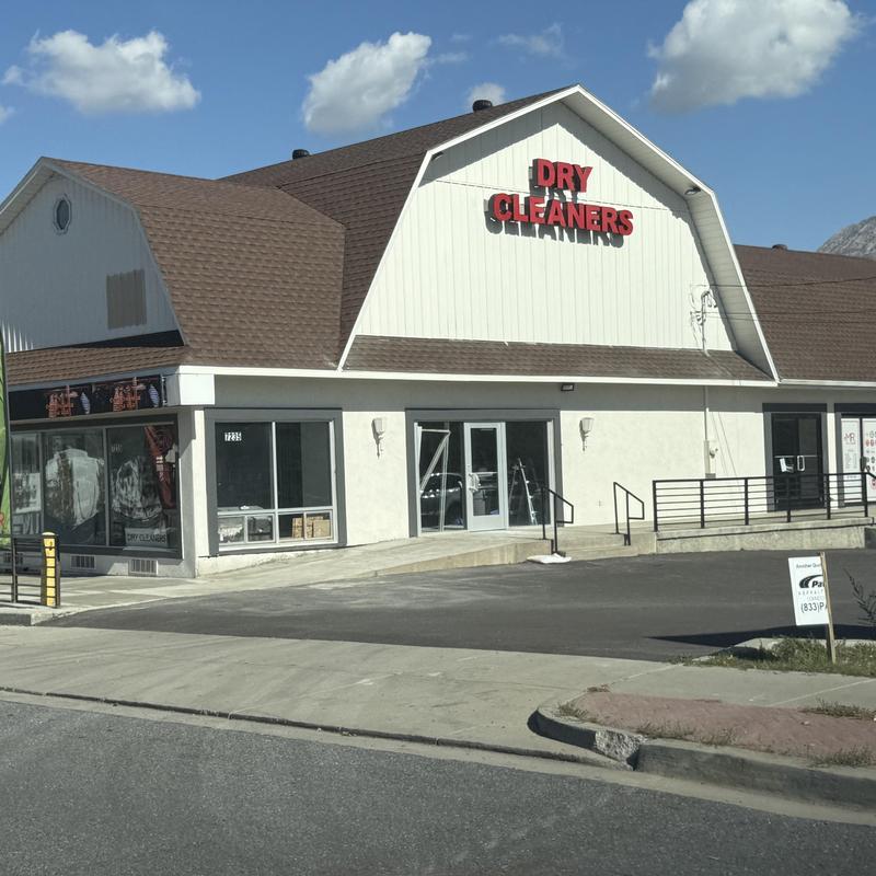 Asphalt shingle roof on commercial dry cleaners building