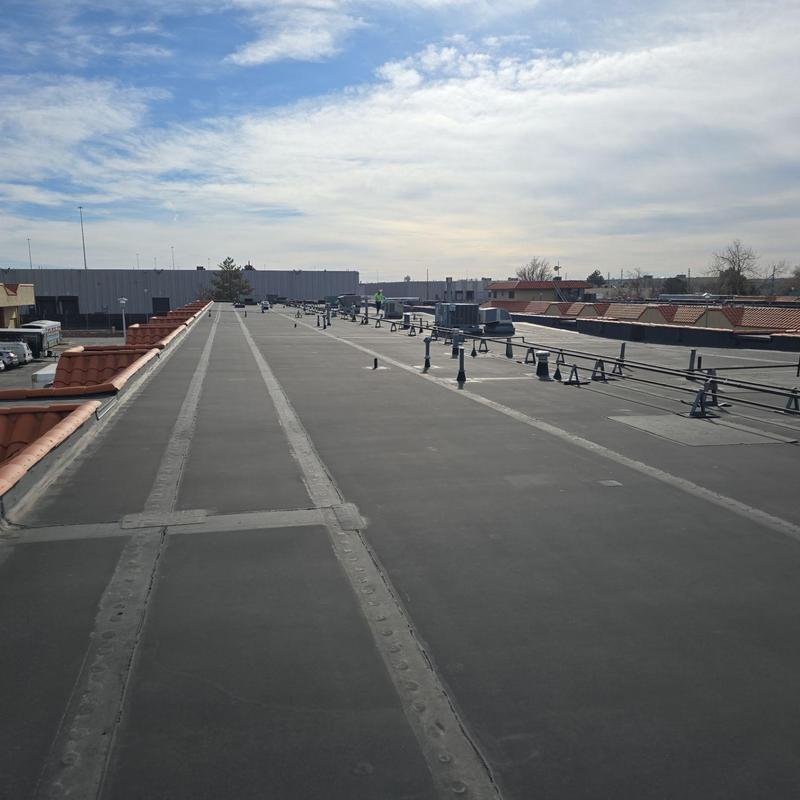 Flat roof with pipe jack seals and punctures
