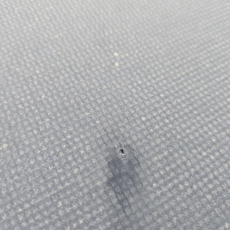 Flat roof membrane puncture with visible damage