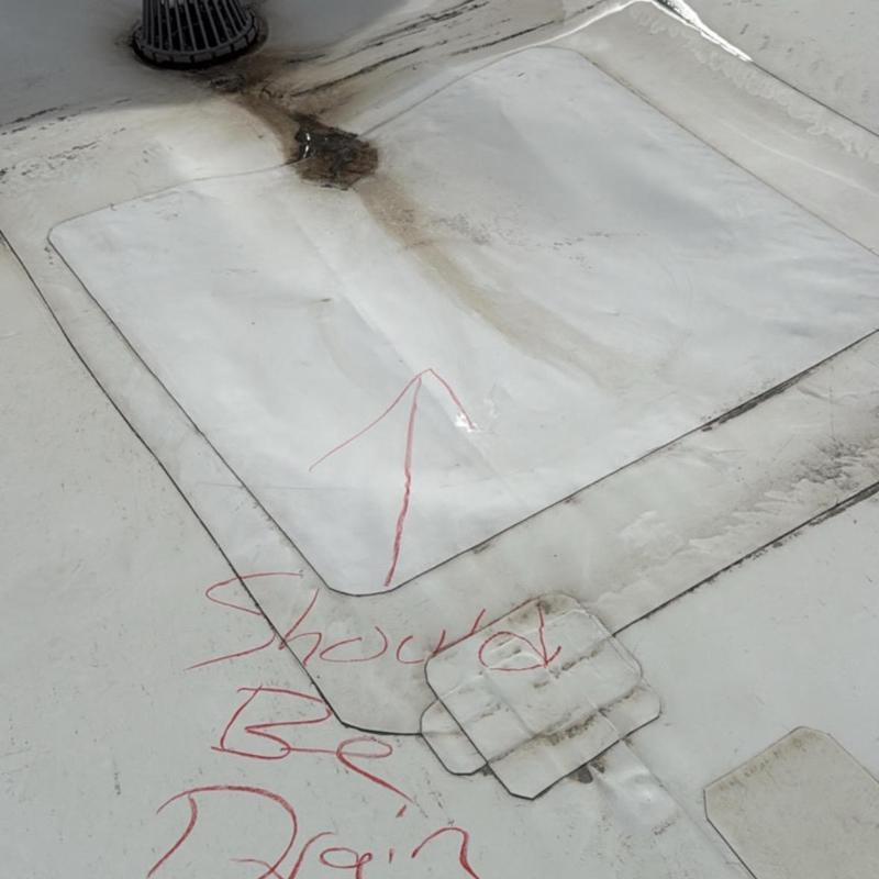 TPO commercial roof membrane with damage and markings