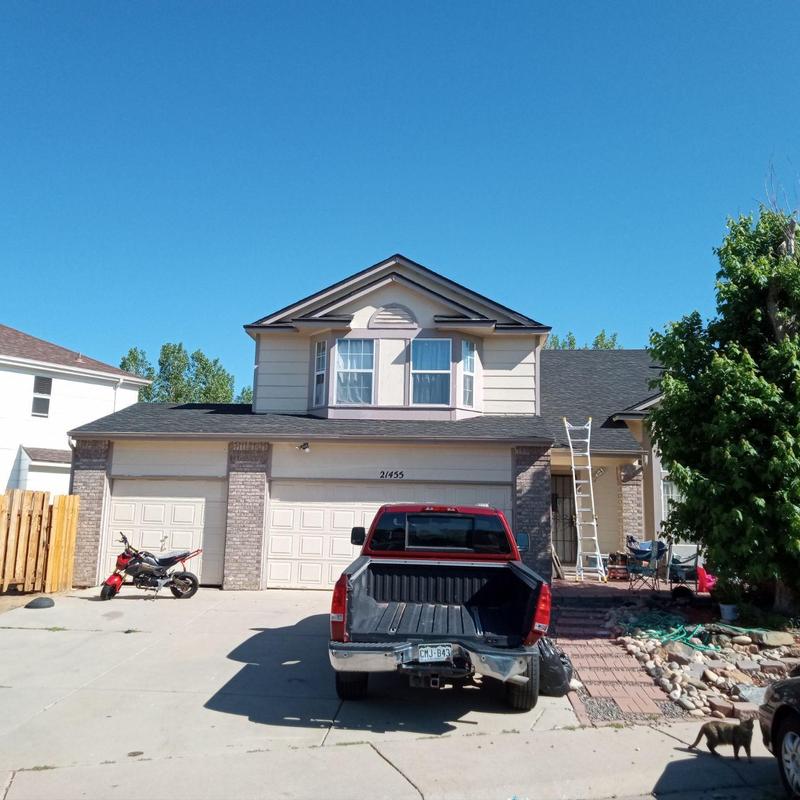 Shingle roof hail damage inspection on suburban home