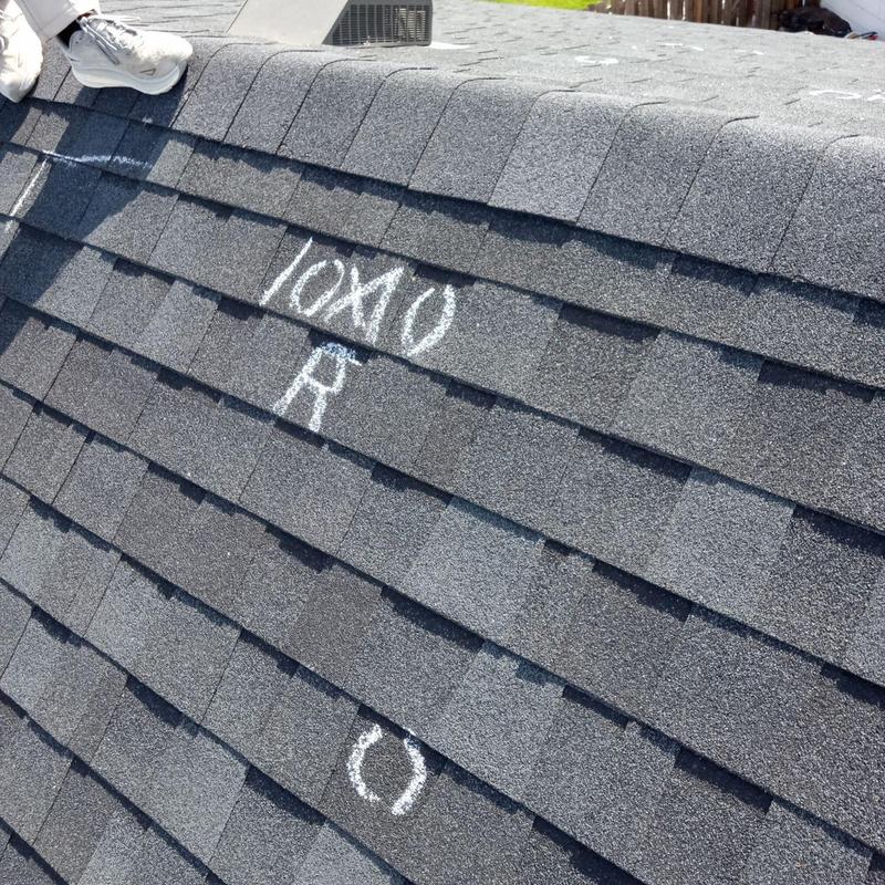 Shingle roof with hail damage markings