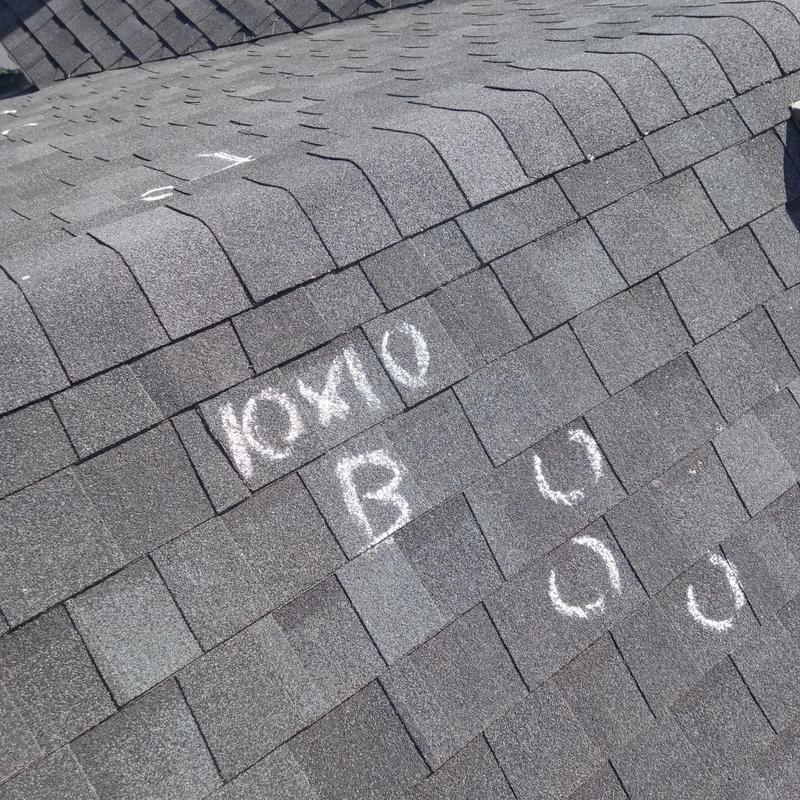 Shingle roof with marked hail damage spots