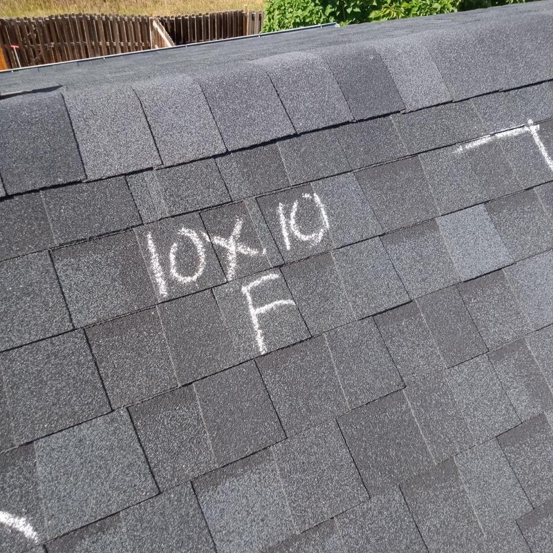 Asphalt shingle roof with hail damage markings