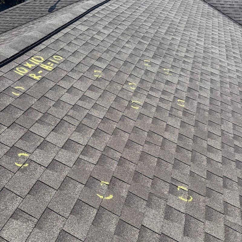 Asphalt shingle roof with hail damage markings