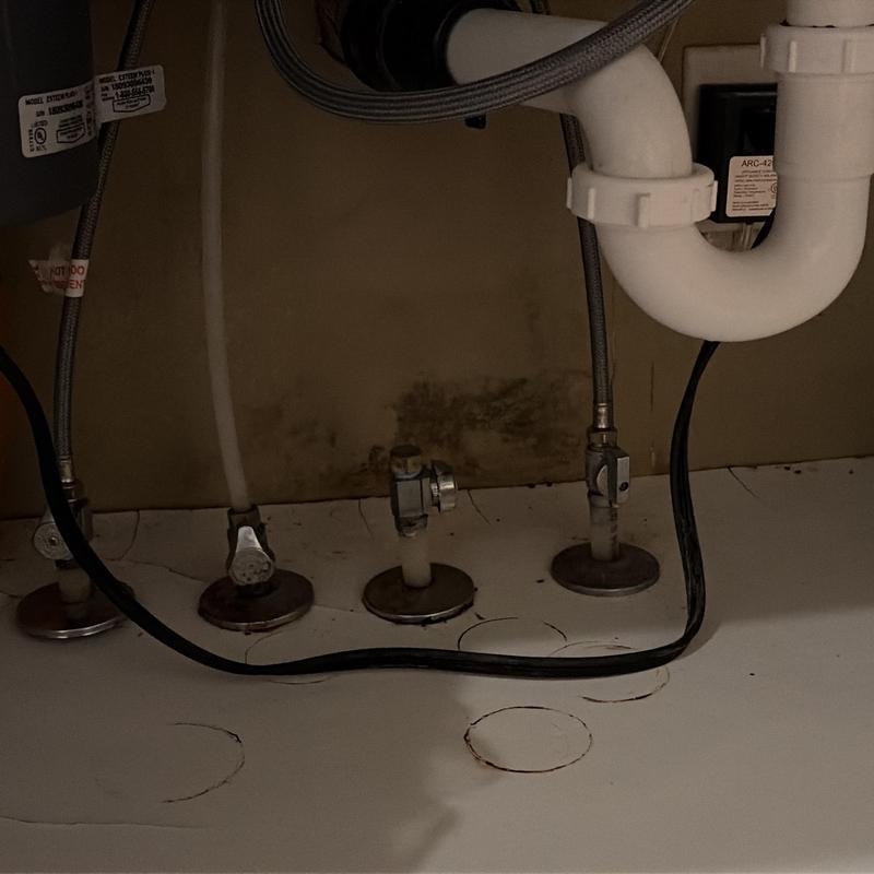 Kitchen faucet connections and drain pipes under sink Kitchen faucet connections and drain pipes under sink