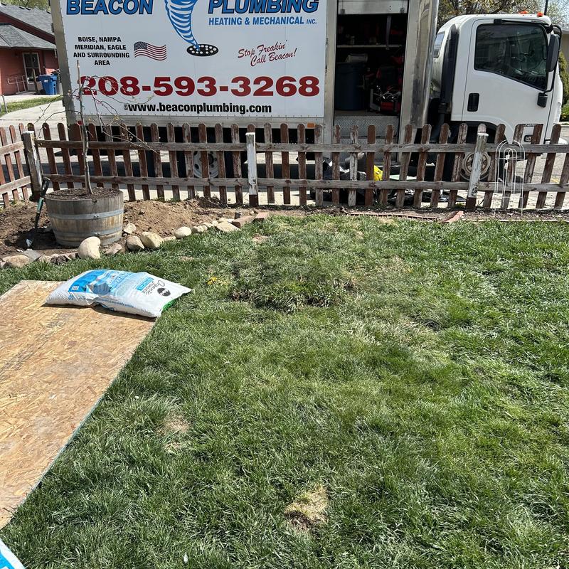 Water service line excavation with Beacon Plumbing truck