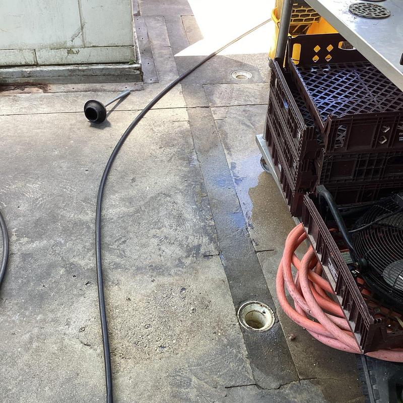 Floor drain with commercial jetting hose at restaurant