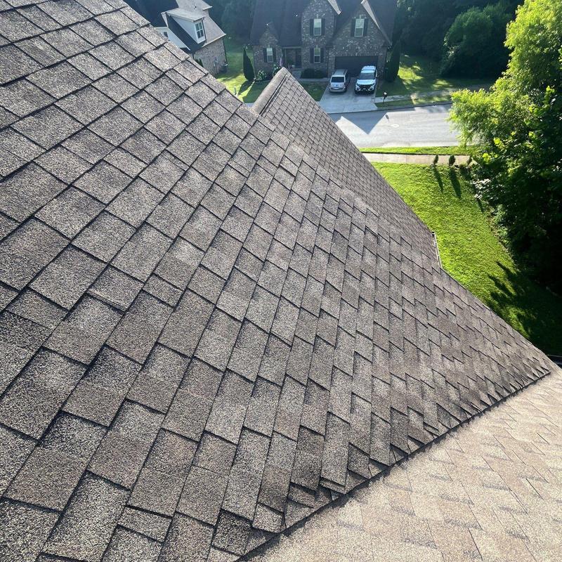 Asphalt shingle roof inspection with visible wear