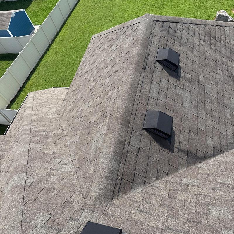 Architectural shingle roof with ventilation caps and hail damage