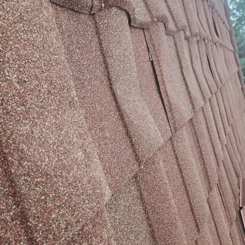 Stonecoated steel roof panel with damage and misfastening