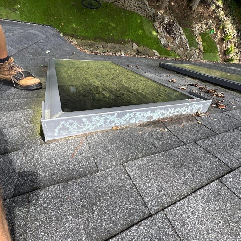 Skylight window frame corrosion on asphalt shingle roof