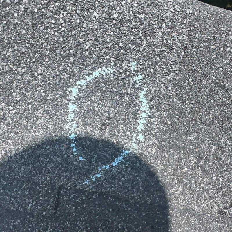 Asphalt shingle roof hail damage marked with chalk