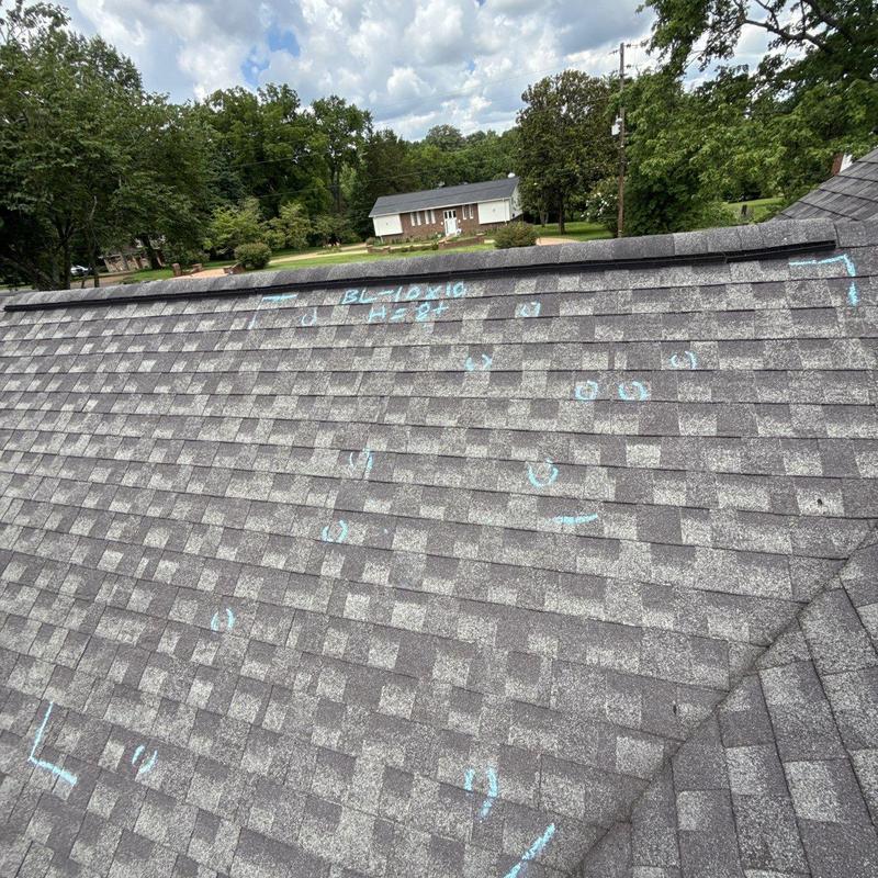 Asphalt shingle roof with hail damage markings