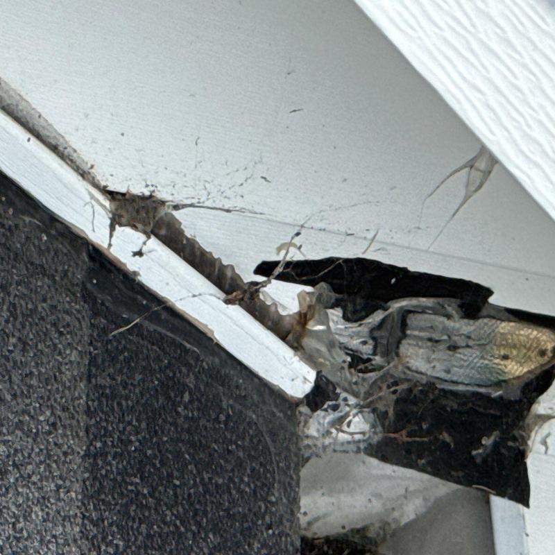 Soffit board with water damage and cracking paint