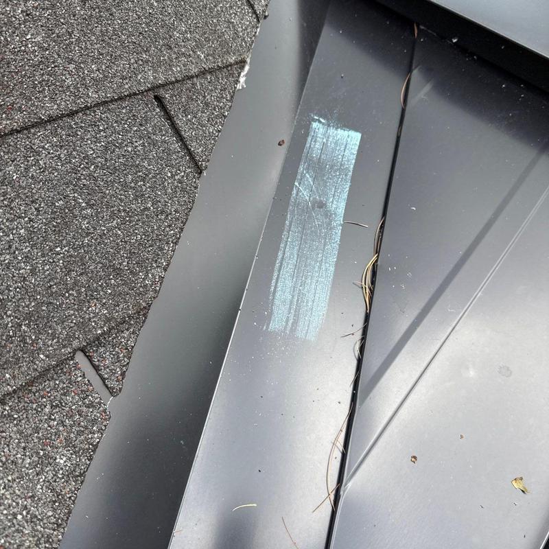 Metal roof flashing with hail impact marks