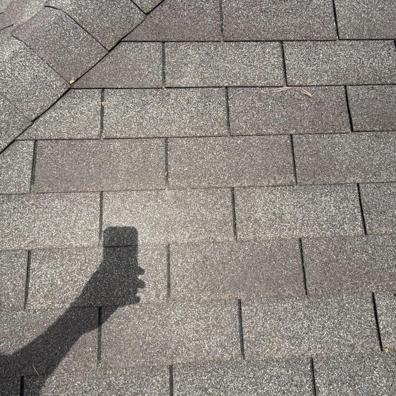 Asphalt shingle roof with hail impact wear and damage