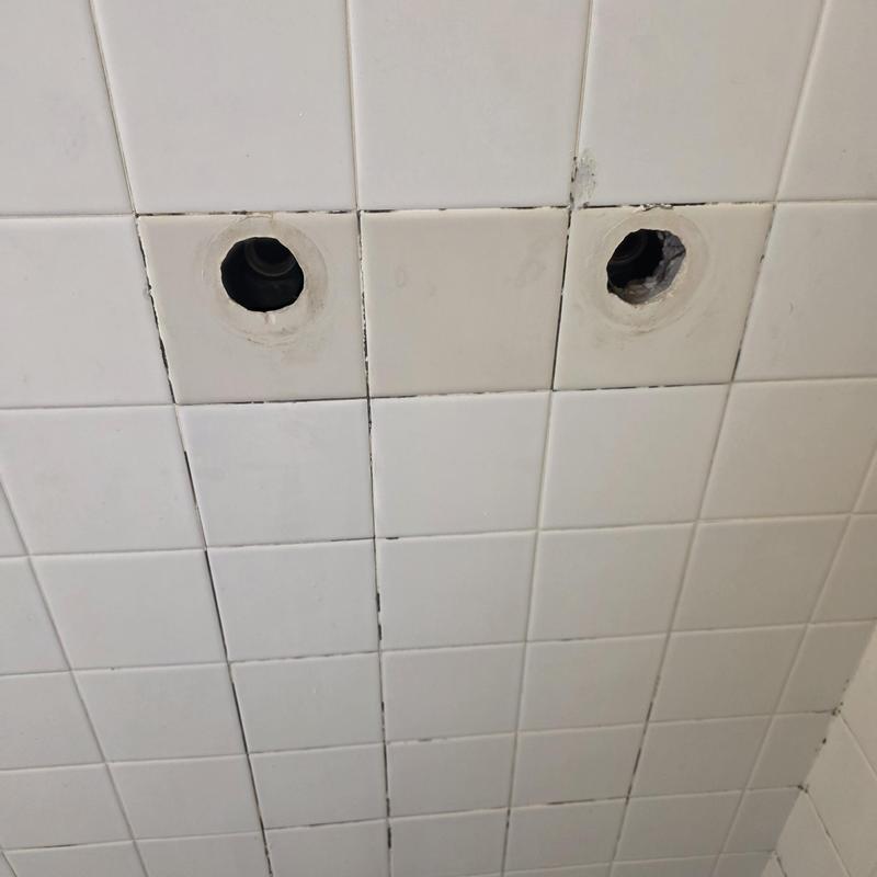Shower valve stems replacement with wall tile background