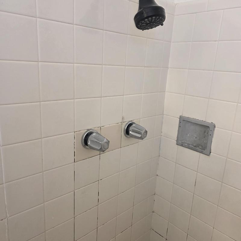 Shower stems replacement with chrome handles in tiled wall