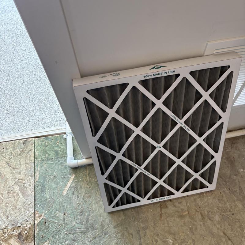 HVAC air filter removed next to vent and floor