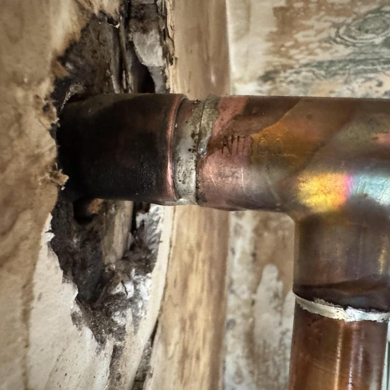 Copper cold water line soldered joint in wall cavity