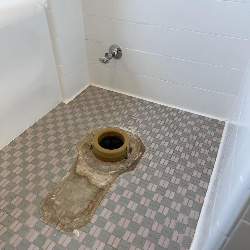 Toilet flange installation on tiled bathroom floor