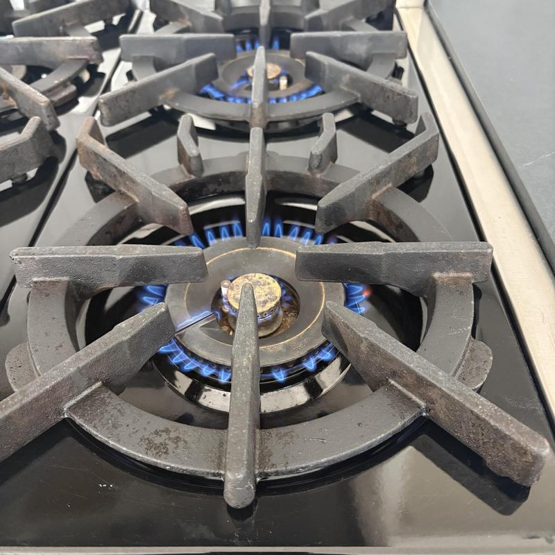 Gas stove burners with active blue flames