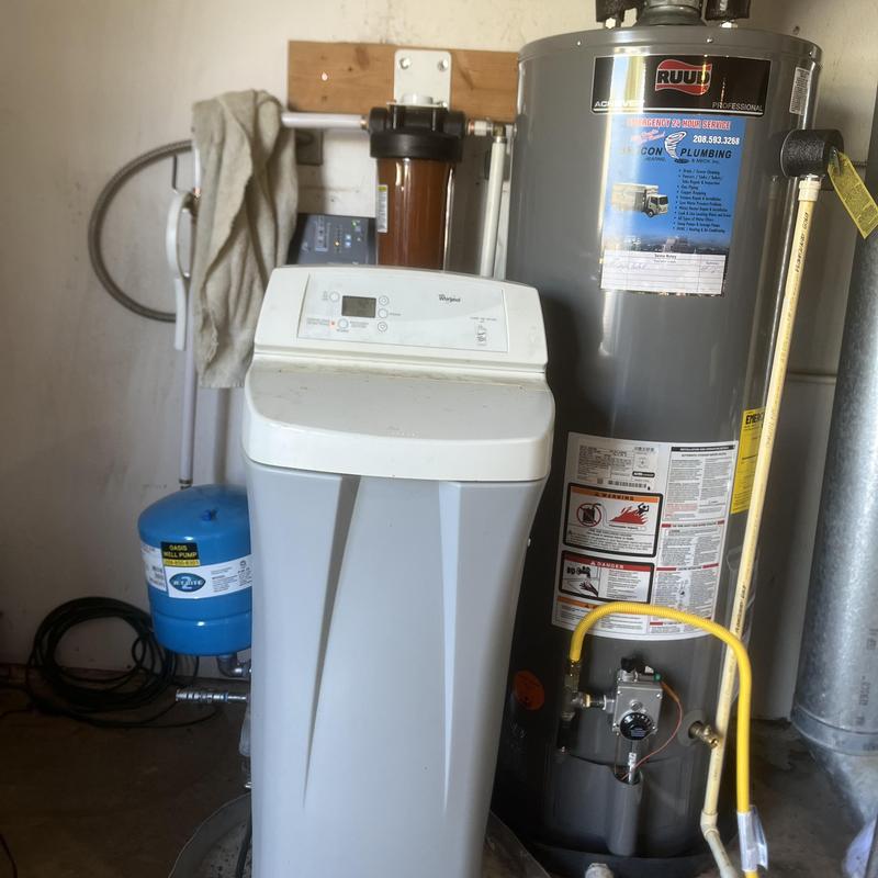 Water heater and water softener installation in utility room Water heater and water softener installation in utility room