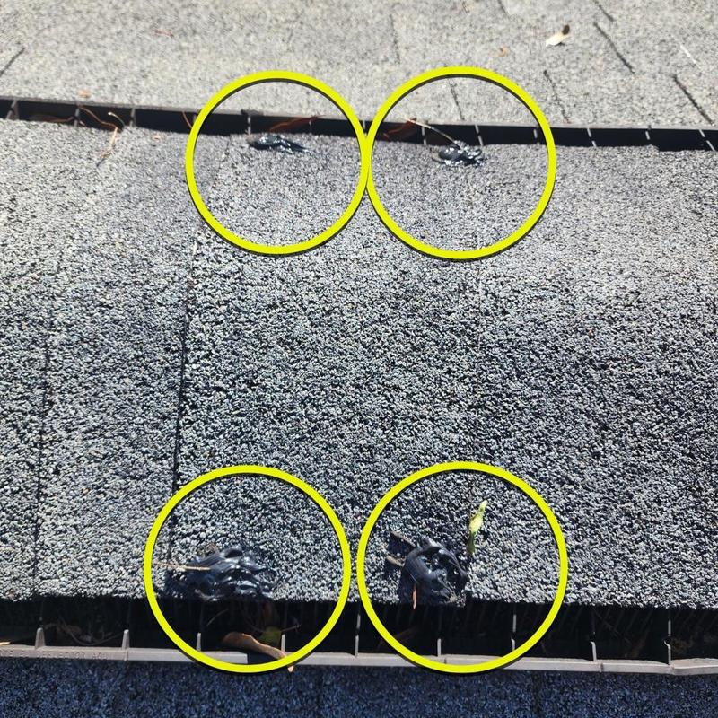 Roof shingles with tar patch repairs highlighted