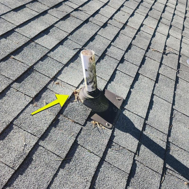 Roof vent pipe flashing with wear and debris on shingles
