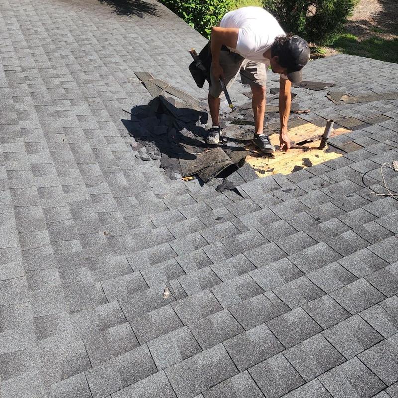 Pipe boot and roof shingle repairs on gray roof