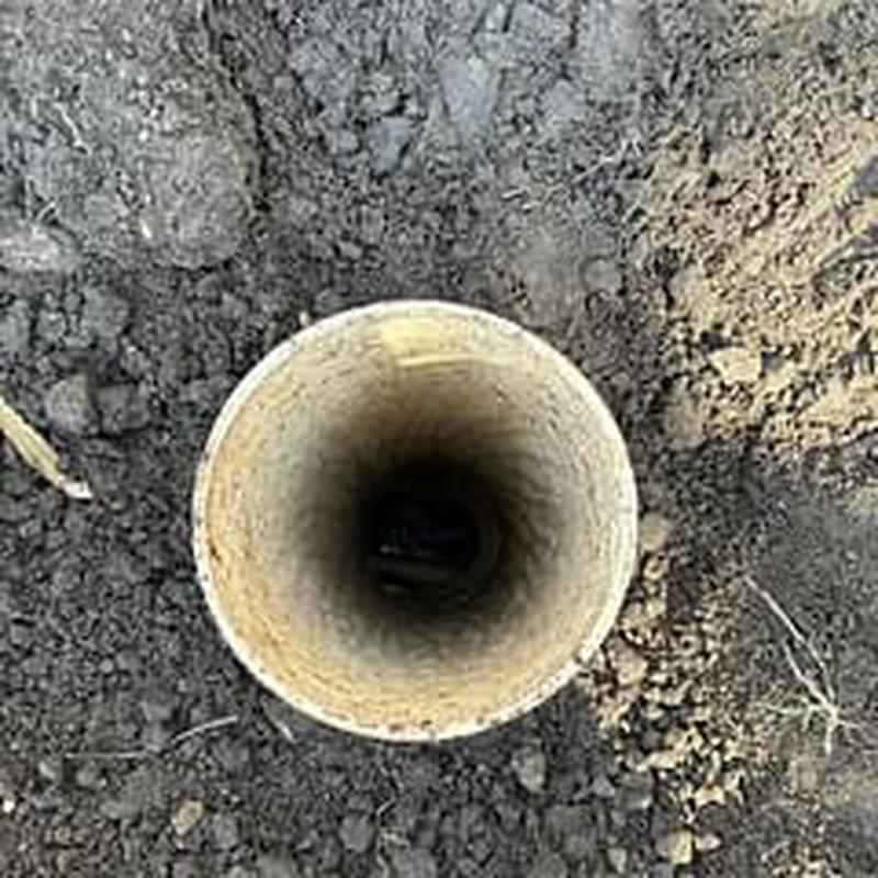 Main sewer clean out pipe in dirt ground
