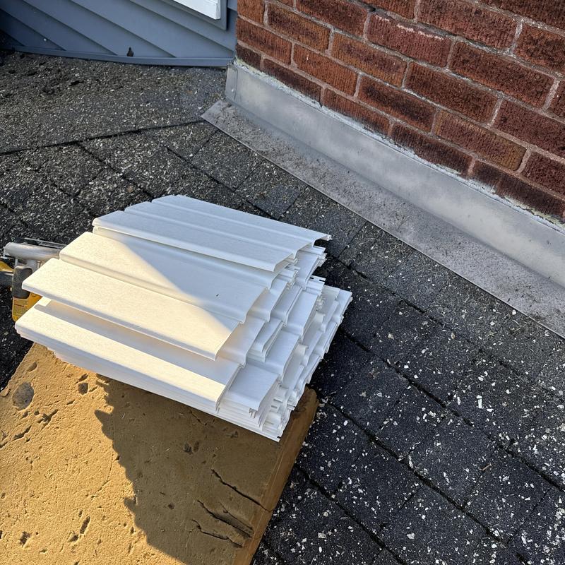 Soffit and fascia panels stacked on roof shingles Soffit and fascia panels stacked on roof shingles