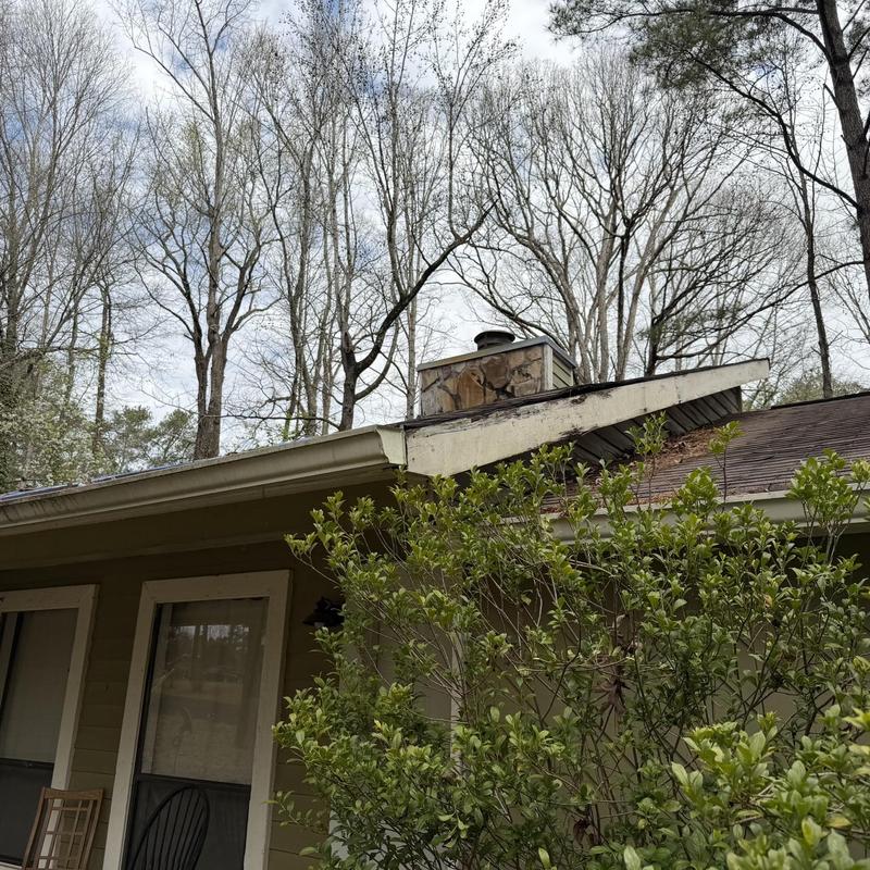 Roof decking boards and chimney cap on residential roof