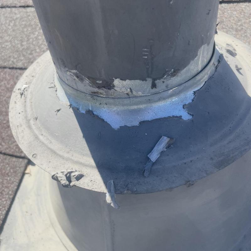 Vent pipe flashing with deteriorated sealant and damage