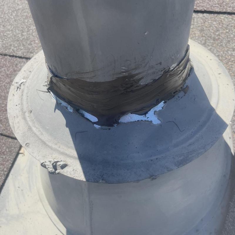 Pipe boot flashing with sealant repair on roof