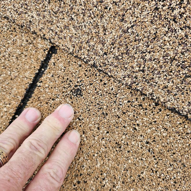 Asphalt shingle roof with hail damage close-up