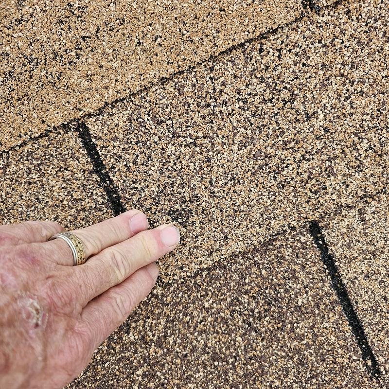 Asphalt roof shingles with hail damage inspection