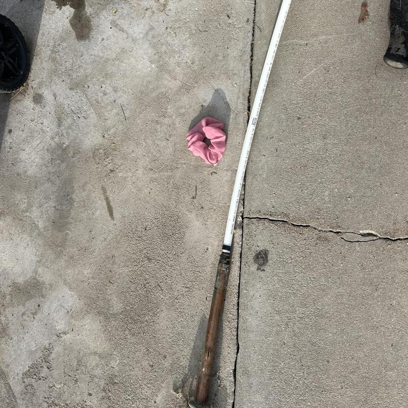 Frozen split hose bib with attached PEX loop on concrete