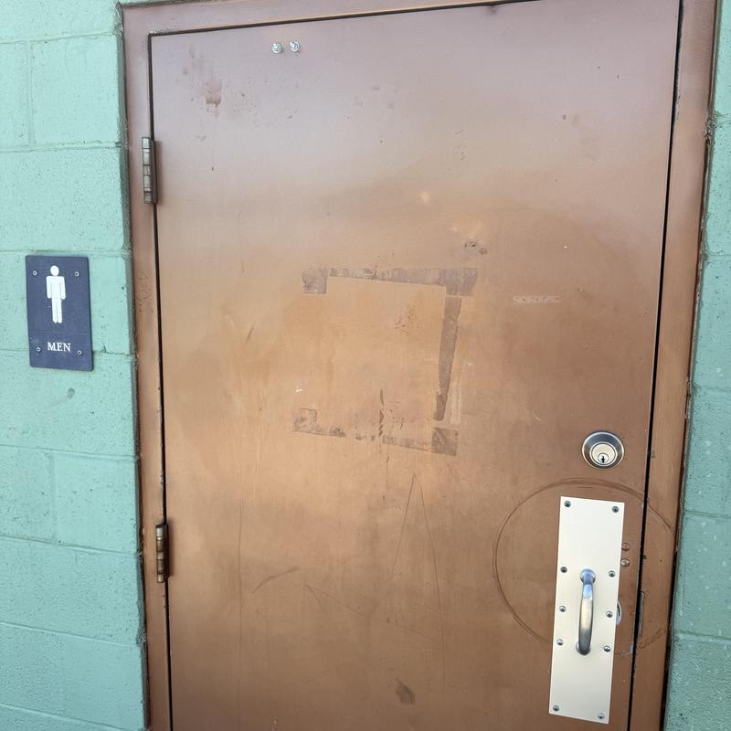 Restroom door pull handle with new hardware installed