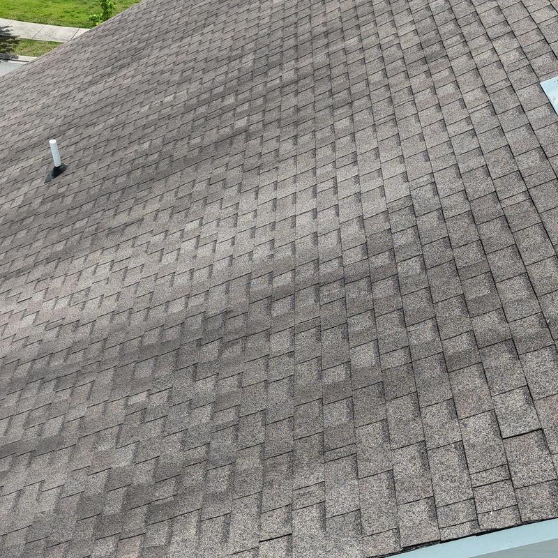 Asphalt shingle roof with visible hail damage inspection