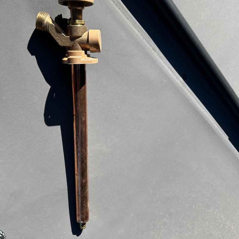 Outdoor hose bib spigot with extending pipe on surface Outdoor hose bib spigot with extending pipe on surface