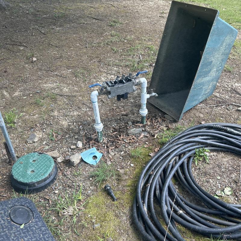 Backflow valve assembly and irrigation pipes outdoors Backflow valve assembly and irrigation pipes outdoors