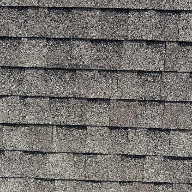 Asphalt roof shingles with hail damage signs