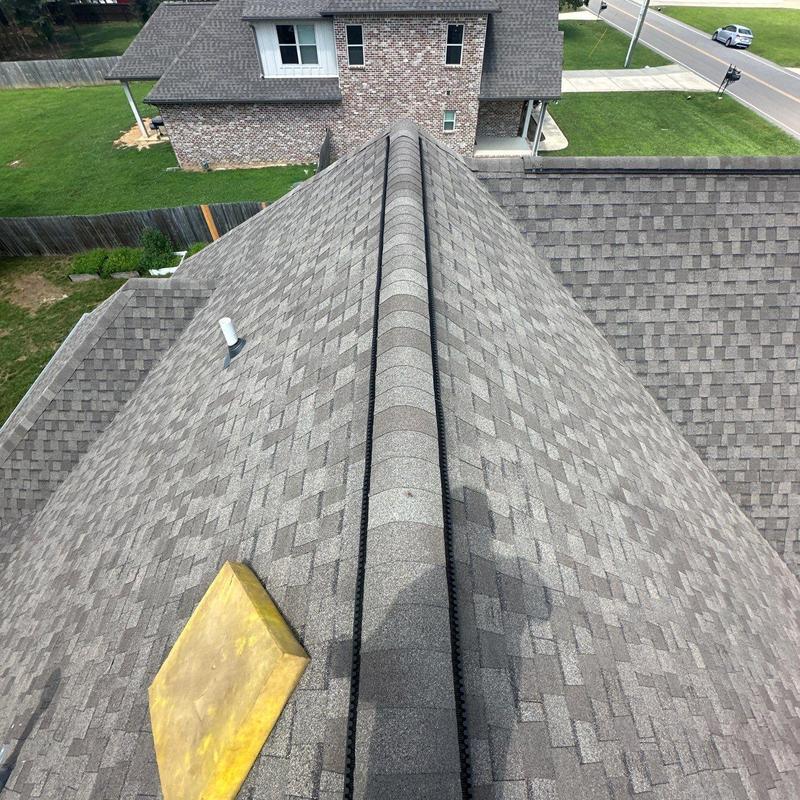 Roof ridge shingles with hail damage and repairs needed