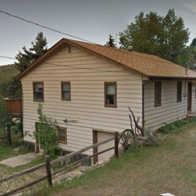Shingle roof on residential home with wooden fence