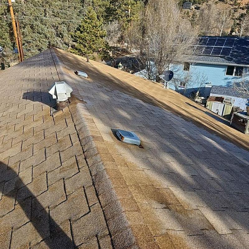 Shingle roof with vent pipes and ridge cap