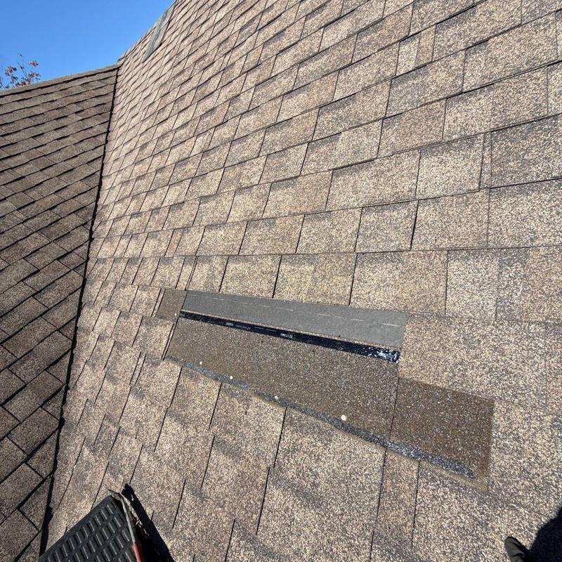Asphalt shingles showing hail damage on roof surface