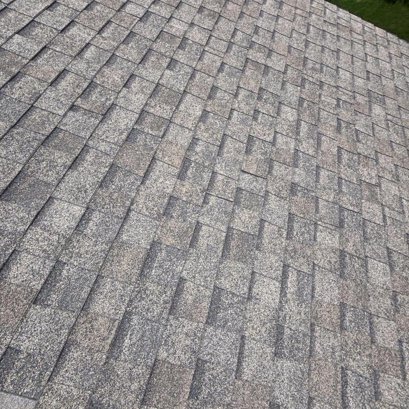 Asphalt roof shingles with hail damage and wear