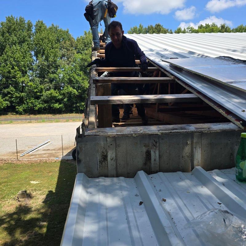 Metal roof panel removal and inspection on commercial building